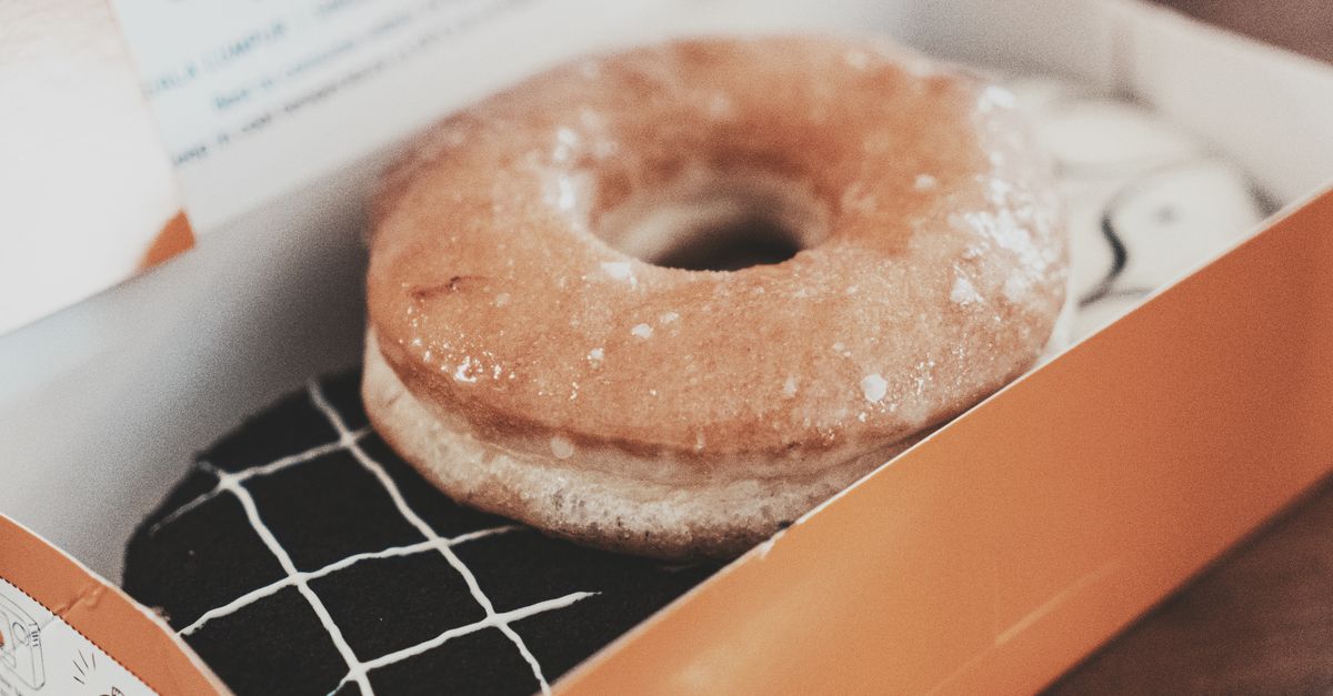 Delicious glazed donut in a box, perfect for sweet indulgence. Photographed in Bandung.